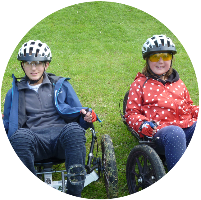 Two teenagers riding accessible bikes
