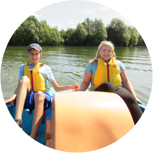 Two teenagers on a pedalo boat.