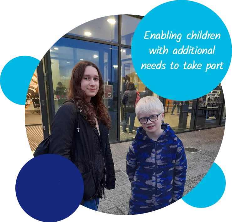 A volunteer and child standing outside a leisure centre. The text reads "Enabling children with additional needs to take part"